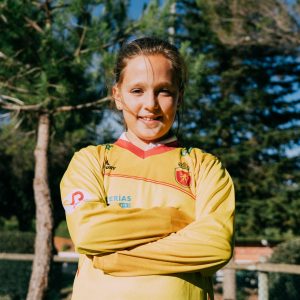niña de brazos cruzados con la camiseta oficial de portera de la selección española femenina de hockey hierba